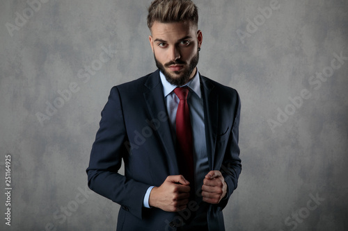 serious businessman holding his suit's collar