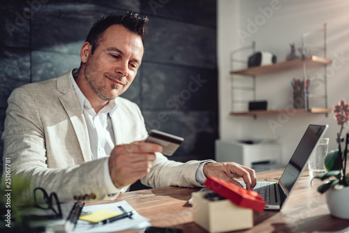 Men shopping online and using credit card © kerkezz