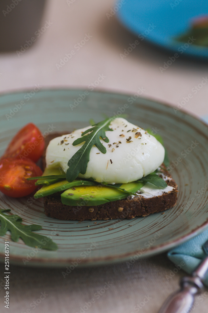 sandwich with avocado, poached egg, arugula and cherry tomatoes sandwich with avocado, poached egg, arugula and cherry tomatoes