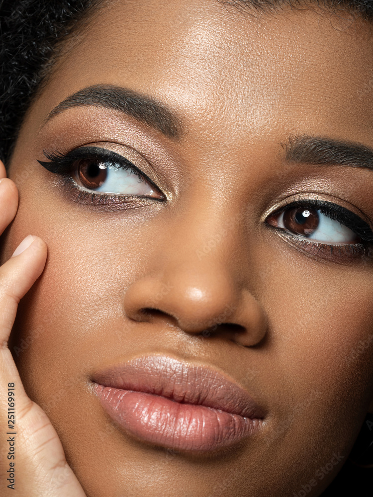 Closeup Portrait Of Young Beautiful Black Woman Touching Her Face closeup-portrait-of-young-beautiful-black-woman-touching-her-face