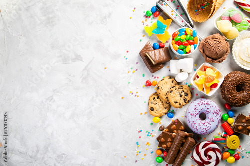 Selection of colorful sweets - chocolate, donuts, cookies, lollipops, ice cream top view