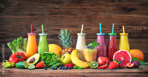 Fototapeta Naklejka Na Ścianę i Meble -  Colorful freshly squeezed fruits and vegetables smoothies with ingredients for healthy eating
