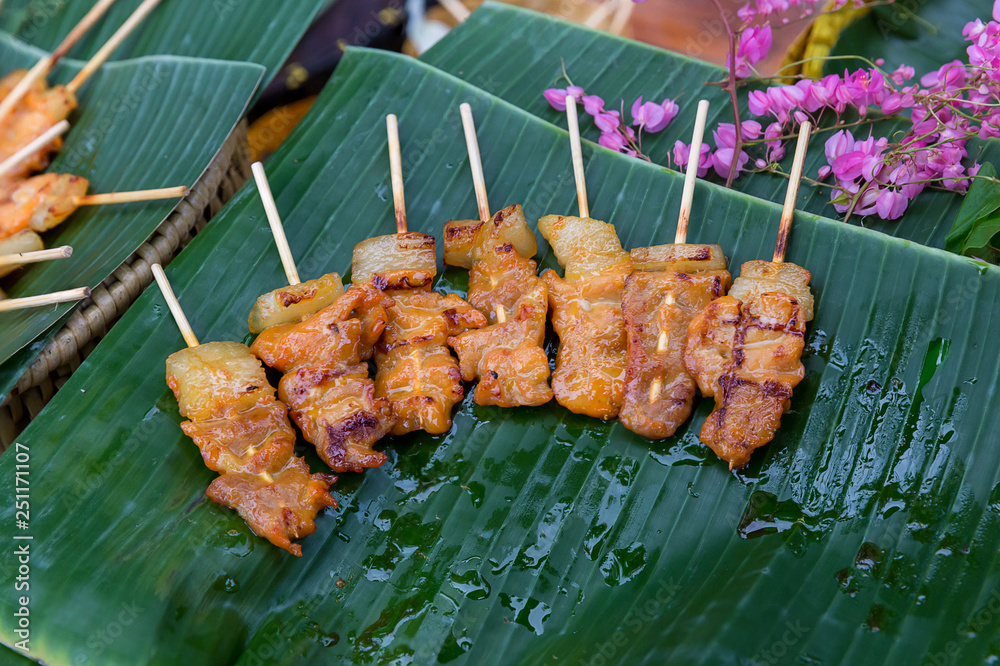 Barbecue pork Toast grill or Toast pork with Thai garnish nutrition preparation for cooking. Thai food, Street food.Pork satay grilling on stove or Thai style roasted pork at the market.
