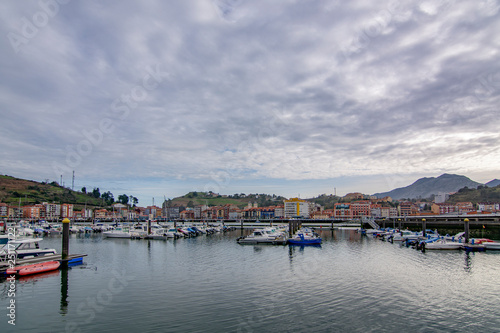 Sailing ships and yachts stand moored in Ribadesella port