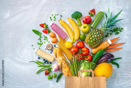 Shopping bag with groceries full of fresh vegetables and fruits photo