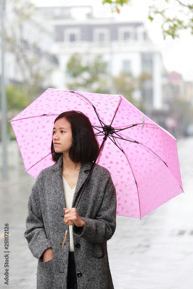 woman walking with an umbrella in the rain