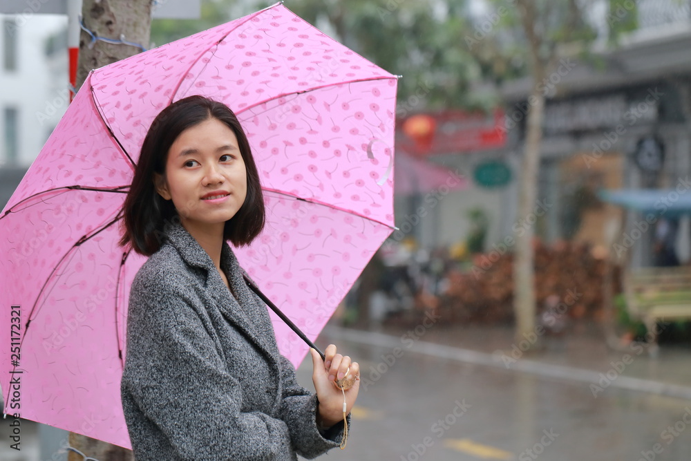 woman walking with an umbrella in the rain