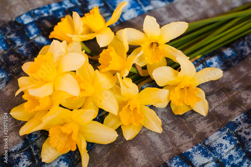 Bouquet beautiful yellow daffodils on a silk scarf. Close-up. photo