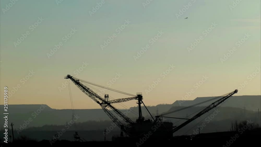 silhouette of an excavator in a career time lapse silhouette of an excavator in a career time lapse