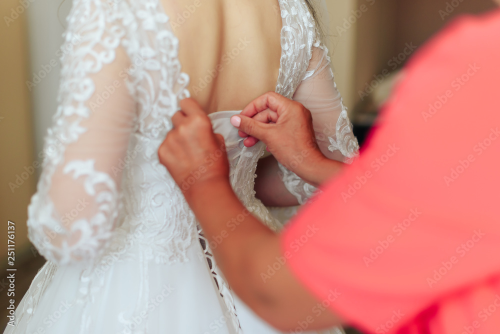 morning of the bride, a beautiful woman in a white dress is preparing for the wedding