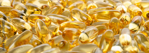 yellow fish oil capsules, omega 3, on white background