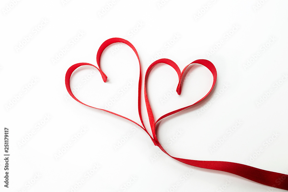 Two hearts tied together made of red ribbon