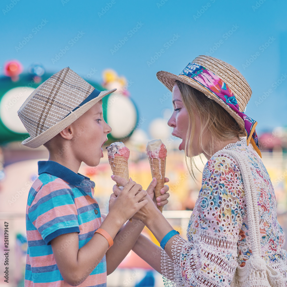 Mom and son eating ice cream at amusement park. Stock Photo | Adobe Stock