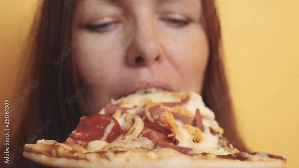 Piece Pizza . happy girl eating a slice of pizza concept . woman hungry eats a slice of pizza. slow motion video. lifestyle pizza fast food concept Piece Pizza . happy girl eating a slice of pizza concept . woman hungry eats a slice of pizza. slow motion video. lifestyle pizza fast food concept