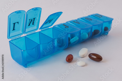 Blue  plastic weekly pills organizer on white background photo