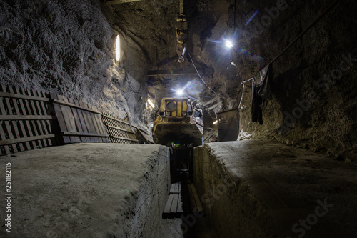 Underground gold ore mine shaft tunnel gallery passage with load, haul, dump machine LHD © Mishainik