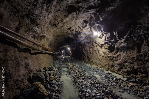 Underground gold ore mine shaft tunnel gallery passage with light © Mishainik