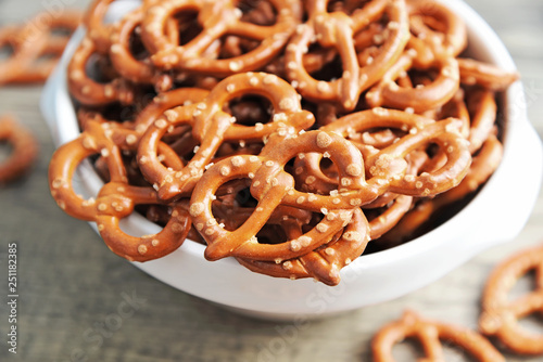 Hard Pretzels or Salted pretzels snack for party in white bowl on wooden floor.