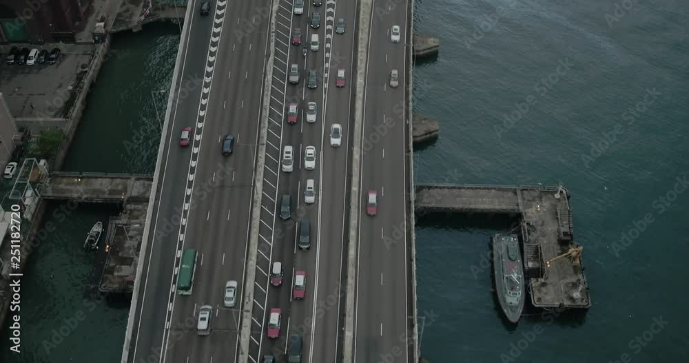 Aerial view of road in Hong Kong city, financial and business district, China, Asia. Moving cars. Aerial view of road in Hong Kong city, financial and business district, China, Asia. Moving cars.
