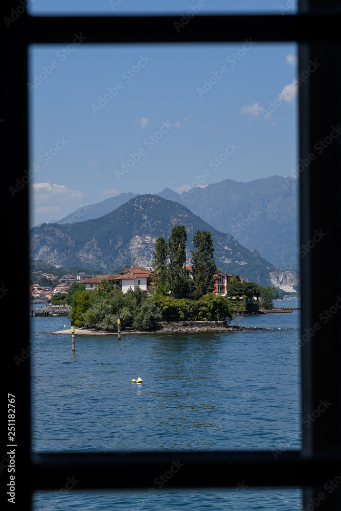 Scenic view towards Isola dei Pescatori on Lake Maggiore, Italy, view from a window