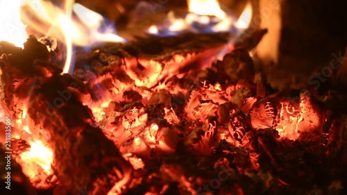 Burning firewoods on embers in fireplace