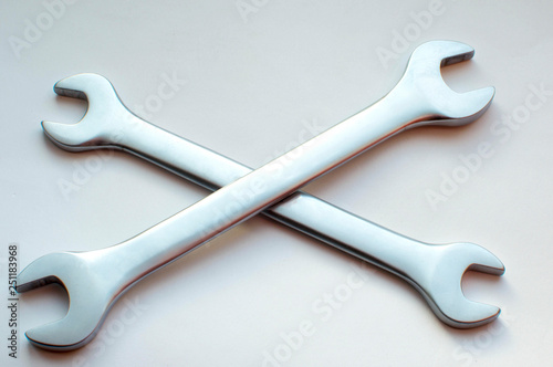 Quadro em tela Two wrenches lie crosswise on a white background