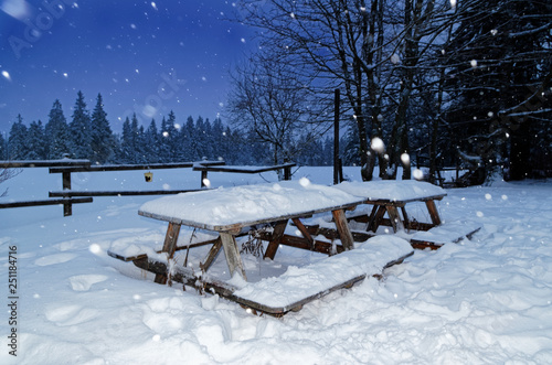 Wooden garden set from table and benches in a winter