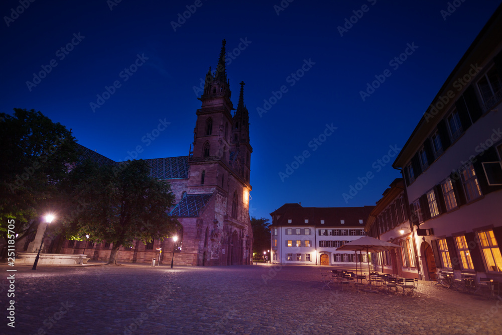 Towers of Basel Minster cathedral against dark sky