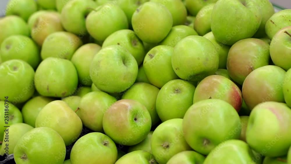 Counter with fruit in supermarket. Fruits in supermarket. Green apple fruits in a supermarket. Bunch of green apples on boxes in supermarket. Counter with fruit in supermarket. Fruits in supermarket. Green apple fruits in a supermarket. Bunch of green apples on boxes in supermarket.