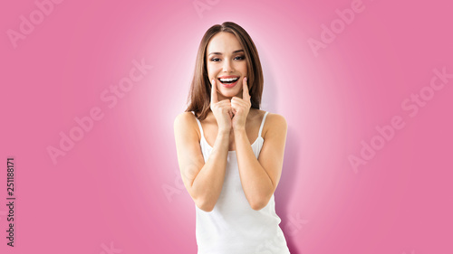 young woman showing smile, on pink