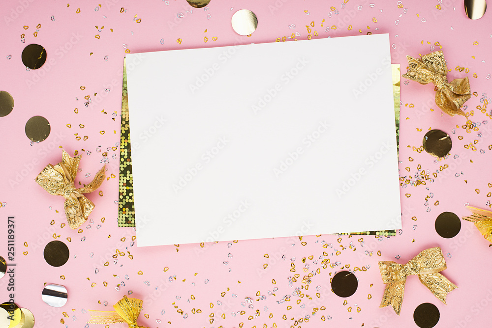 Blank sheet of paper notebook on a festive pink background with golden