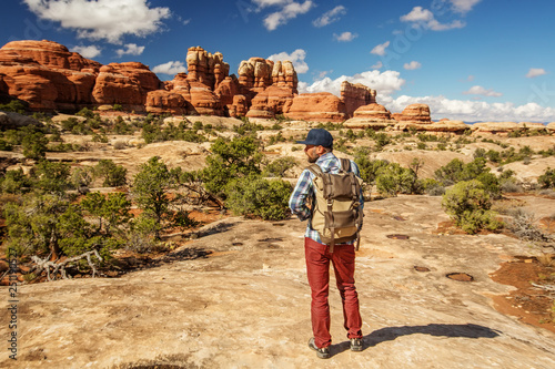 Hiker in Canyonlands National park, needles in the sky, in Utah, USA