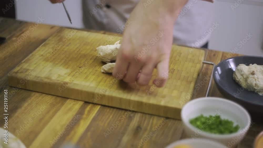 Chef is cutting boiled chicken Chef is cutting boiled chicken