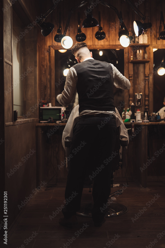 Maintenance client in a barbershop, rear view