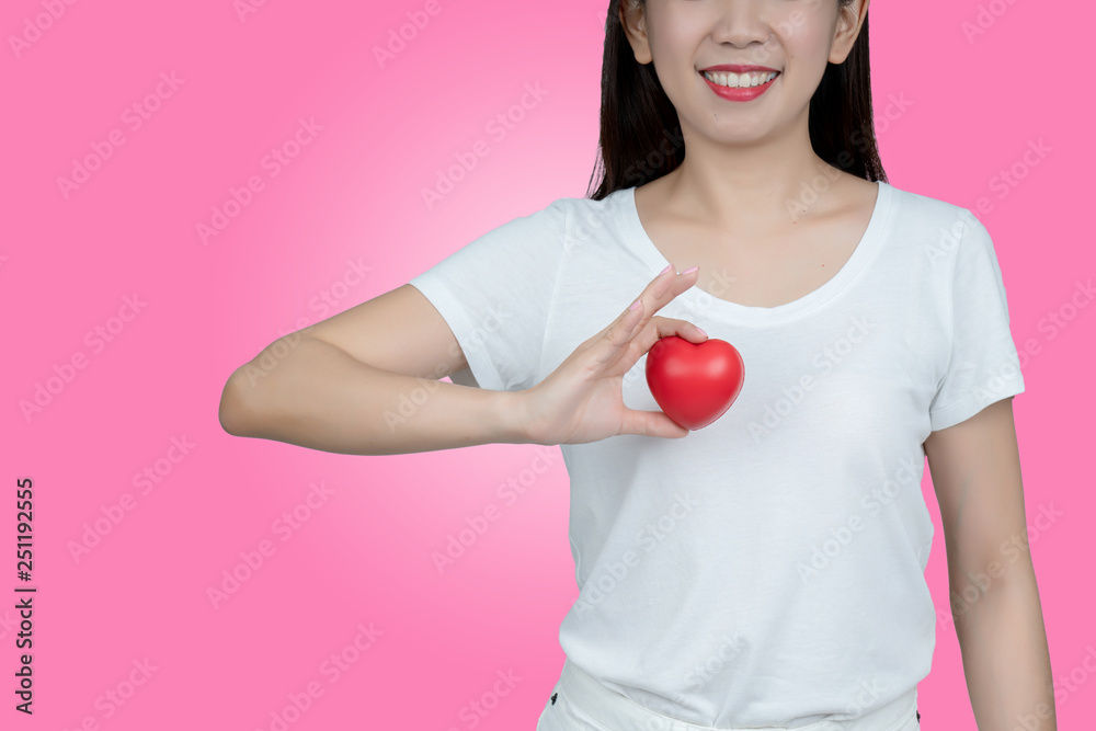 Asian women hand holding red heart in smiley face. Show healthy. Strong heart condition. No complications such coronary artery disease. Be sure to check the body. And health insurance to reduce costs. Asian women hand holding red heart in smiley face. Show healthy. Strong heart condition. No complications such coronary artery disease. Be sure to check the body. And health insurance to reduce costs.