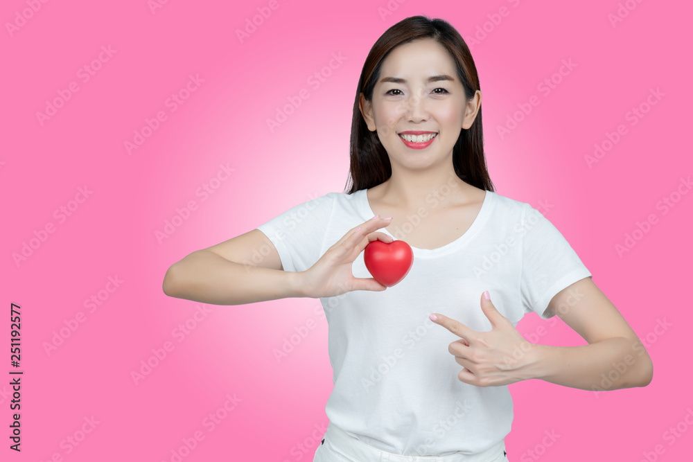 Asian women hand holding red heart in smiley face. Show healthy. Strong heart condition. No complications such coronary artery disease. Be sure to check the body. And health insurance to reduce costs. Asian women hand holding red heart in smiley face. Show healthy. Strong heart condition. No complications such coronary artery disease. Be sure to check the body. And health insurance to reduce costs.