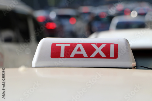 Taxi light sign or cab sign in white and red color with white text on the car roof