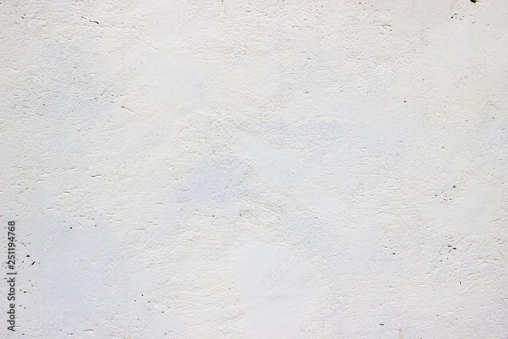 old concrete wall with a layer of whitewash, stucco texture
