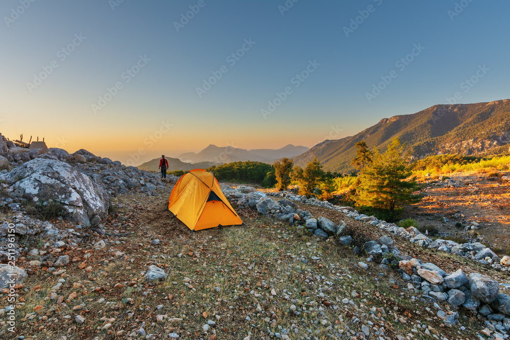 Tourist holiday in a yellow tent in the high mountains overlooking the Mediterranean Sea in Turkeys