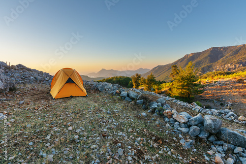 Tourist holiday in a yellow tent in the high mountains overlooking the Mediterranean Sea in Turkeys