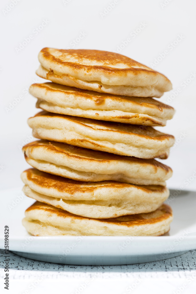 stack of delicious pancakes on a plate, vertical closeup stack of delicious pancakes on a plate, vertical closeup