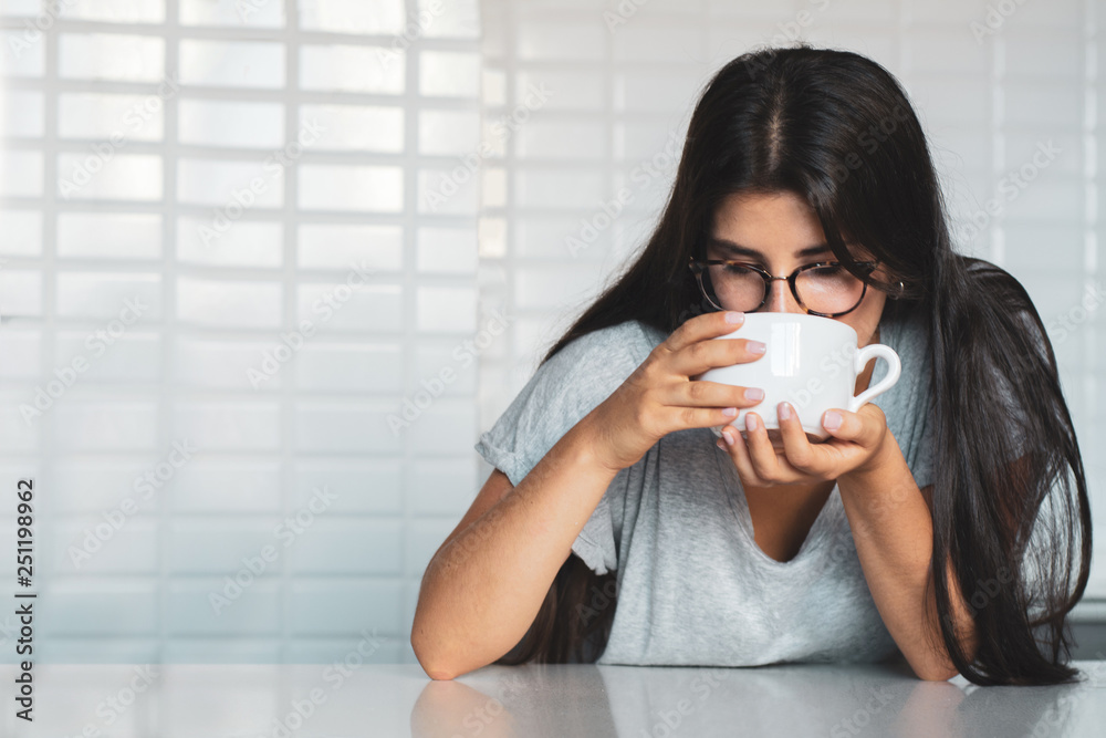 young woman drinking coffee at home