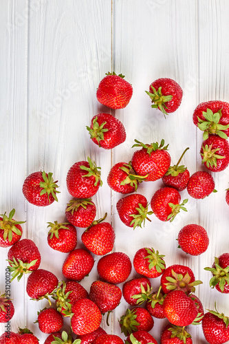 Arrangement of fresh strawberries on white background. Red juicy berries, top view. Healthy summer ingredients.
