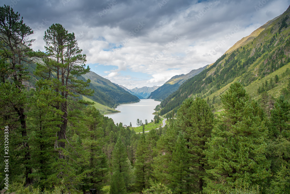 Fototapeta premium The Gepatsch Reservoir, formed by a rockfill dam has a capacity of 30,795 million gallons and is used to generate electricity. The lake is situated in the Kaunertal valley in Tyrol, Austria.