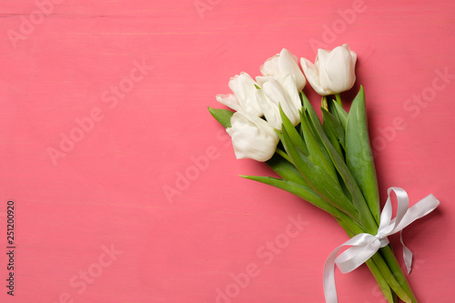 Wallpaper Mural bouquet of white tulips and photo frame with copy space for congratulation text on pink wooden background, banner mockup for Womans day or Easter Torontodigital.ca
