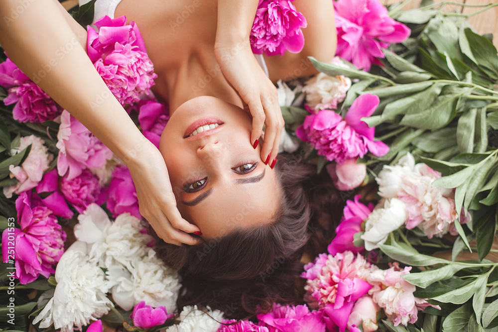Close up portrait of young beautiful woman with flowers indoors Close up portrait of young beautiful woman with flowers indoors