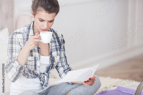 Young attractive woman working at laptop photo