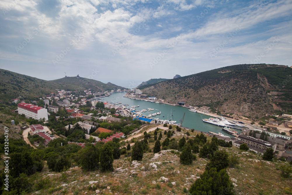 top view of the curved sea Bay and the city Balaklava among the hills