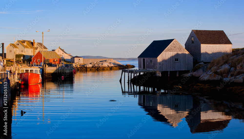 Fishing shacks, boat and buildings at iconic Peggys Cove, Nova Scotia, Canada.