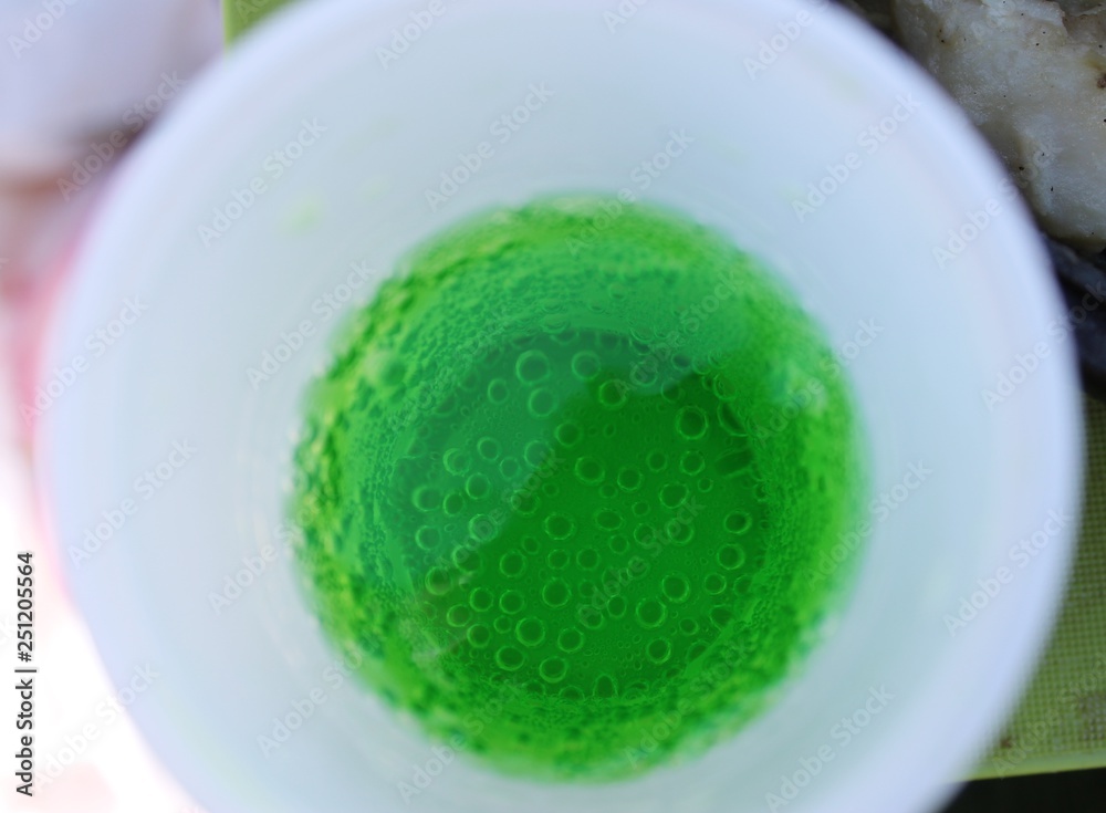 Green lemonade in a plastic Cup